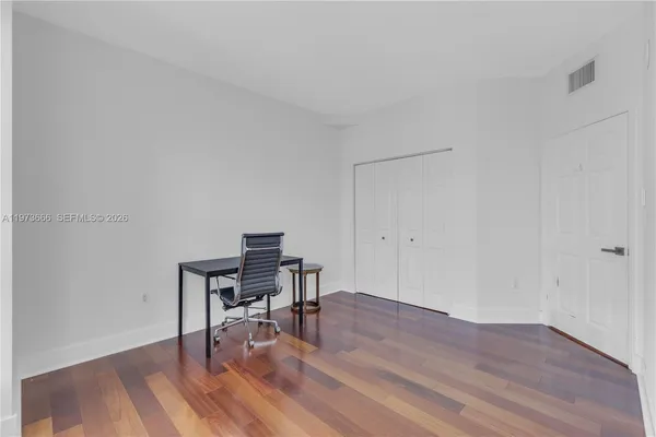 a view of a workspace with wooden floor