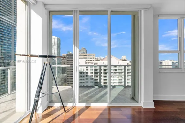 a view of a balcony with wooden floor and door