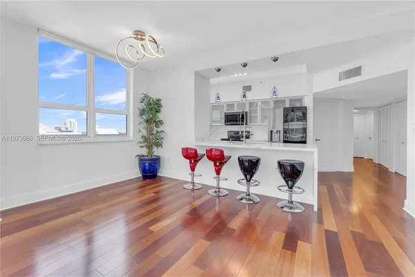 a living room with kitchen island furniture and a wooden floor