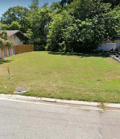 a view of a swimming pool and a yard