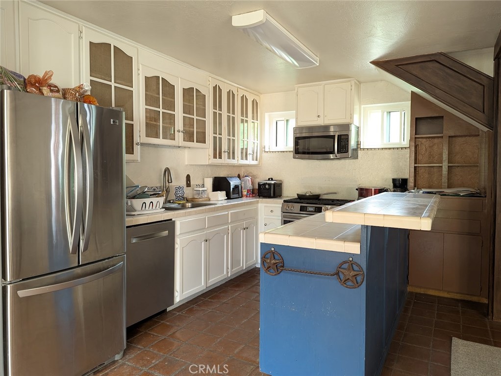 2382 Faber Street Durham, CA 95938 - Photo 6 of 20 a kitchen with stainless steel appliances granite countertop a refrigerator a stove a sink and white cabinets
