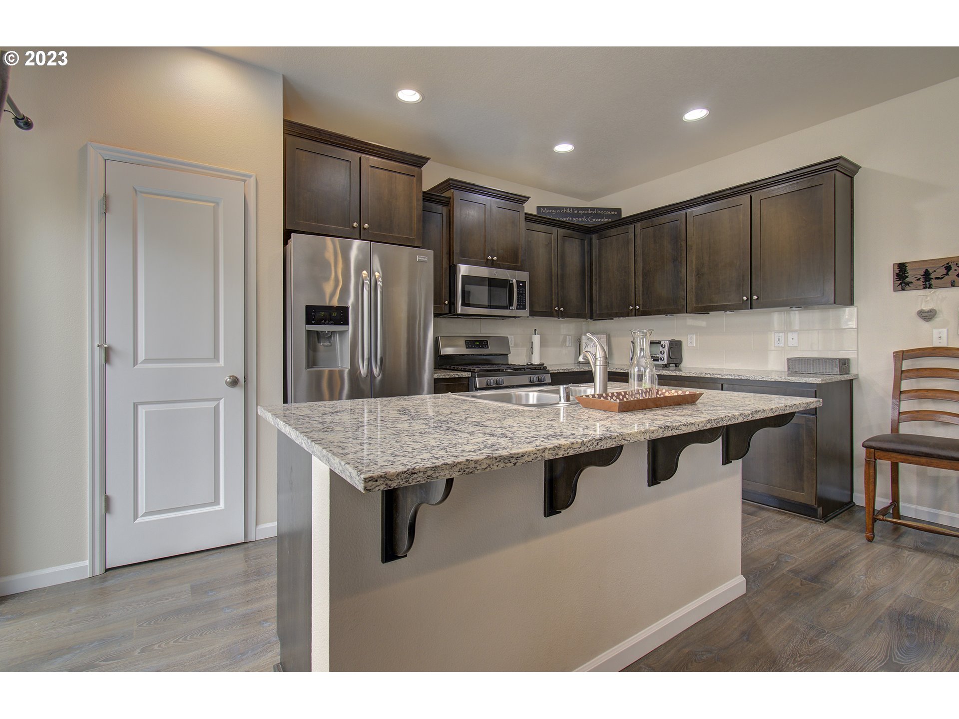 2726 South Red Tail Loop Ridgefield, WA 98642 - Photo 7 of 39 a kitchen with stainless steel appliances granite countertop a sink a stove a refrigerator and a oven
