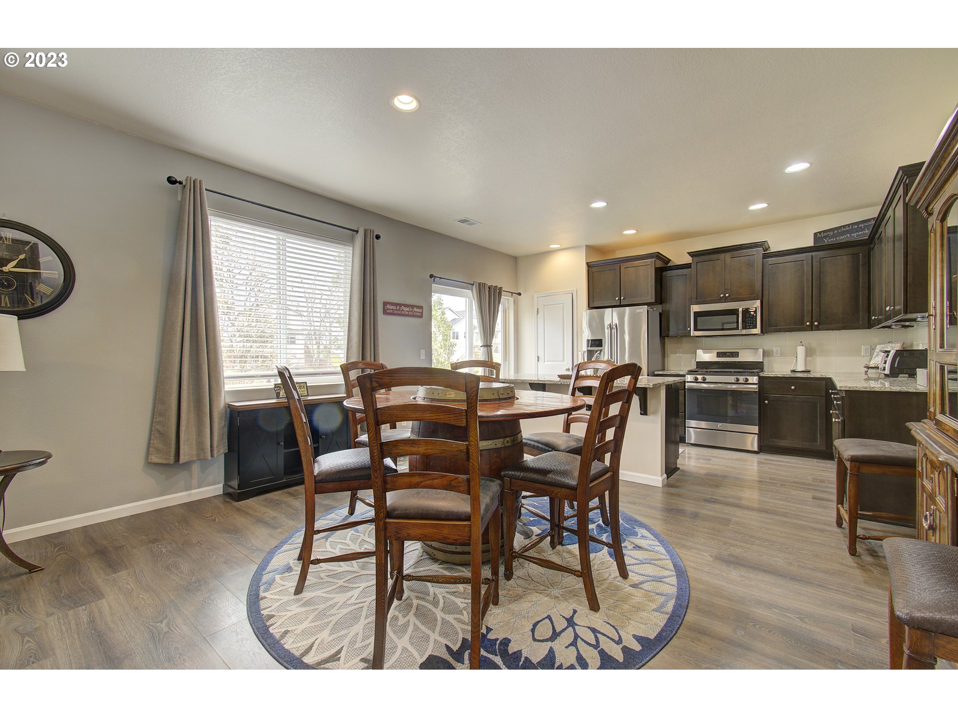 2726 South Red Tail Loop Ridgefield, WA 98642 - Photo 8 of 39 a view of a dining room with furniture and wooden floor