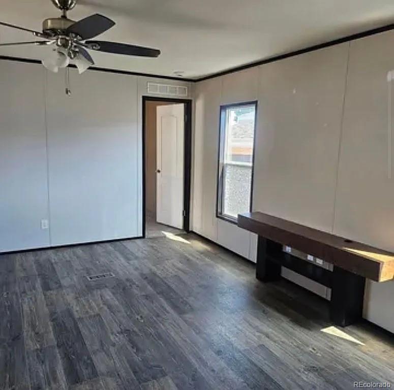 3630 E Street Evans, CO 80620 - Photo 4 of 7 a view of an empty room with wooden floor and a window