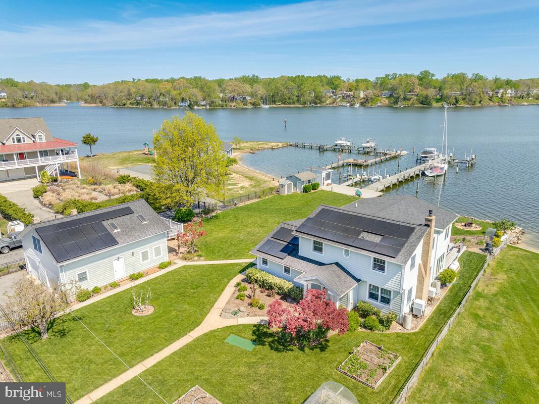 an aerial view of a house with outdoor space and lake view