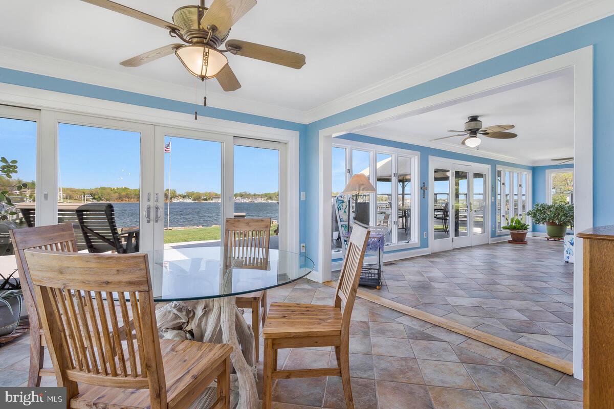 201 Edgewater Drive Edgewater, MD 21037 - Photo 12 of 49 a dining room with furniture a chandelier and wooden floor