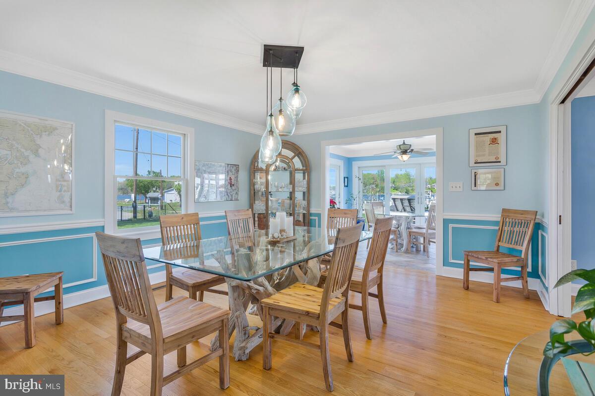 201 Edgewater Drive Edgewater, MD 21037 - Photo 15 of 49 a dining room with furniture a chandelier and wooden floor