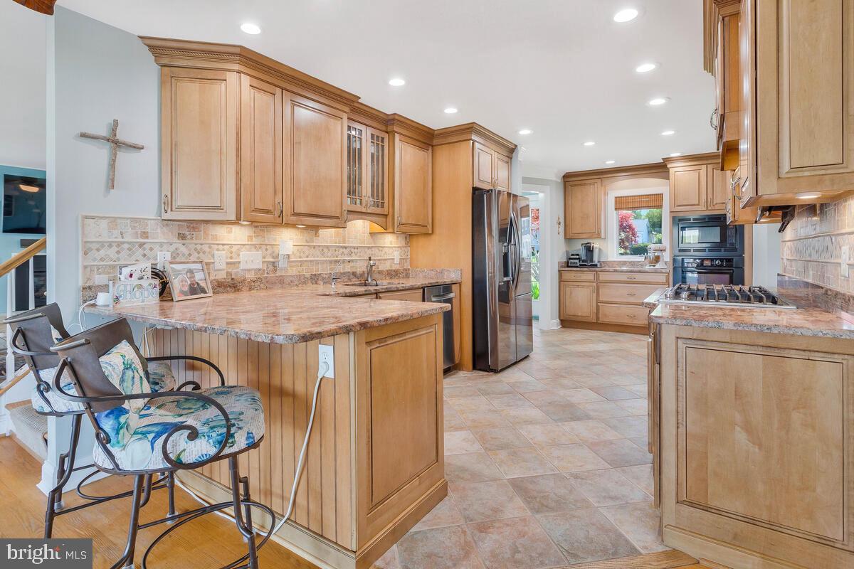 201 Edgewater Drive Edgewater, MD 21037 - Photo 18 of 49 a kitchen with refrigerator cabinets and a stove top oven