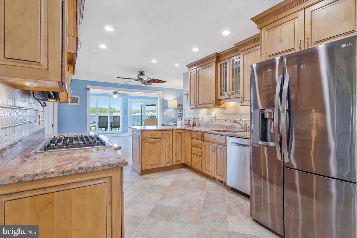201 Edgewater Drive Edgewater, MD 21037 - Photo 19 of 49 a kitchen with a sink refrigerator and cabinets