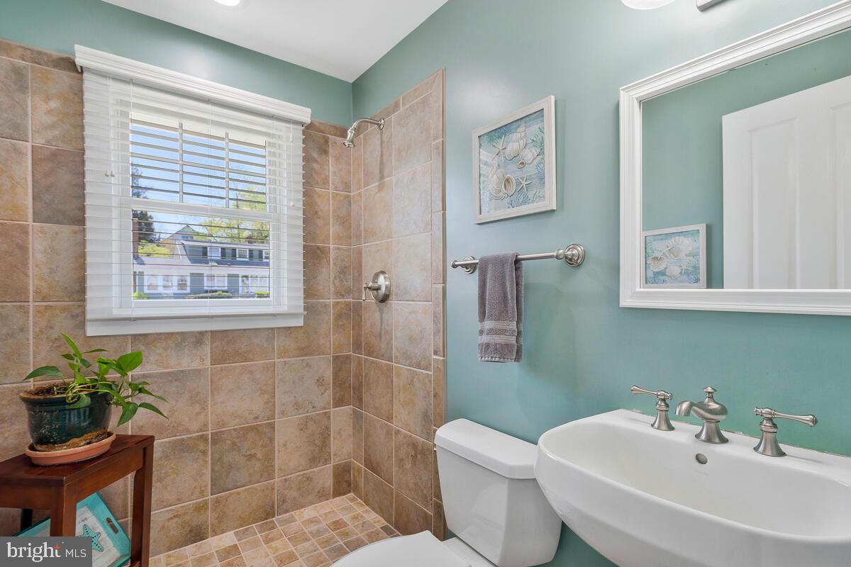 201 Edgewater Drive Edgewater, MD 21037 - Photo 20 of 49 a bathroom with a sink mirror and a toilet