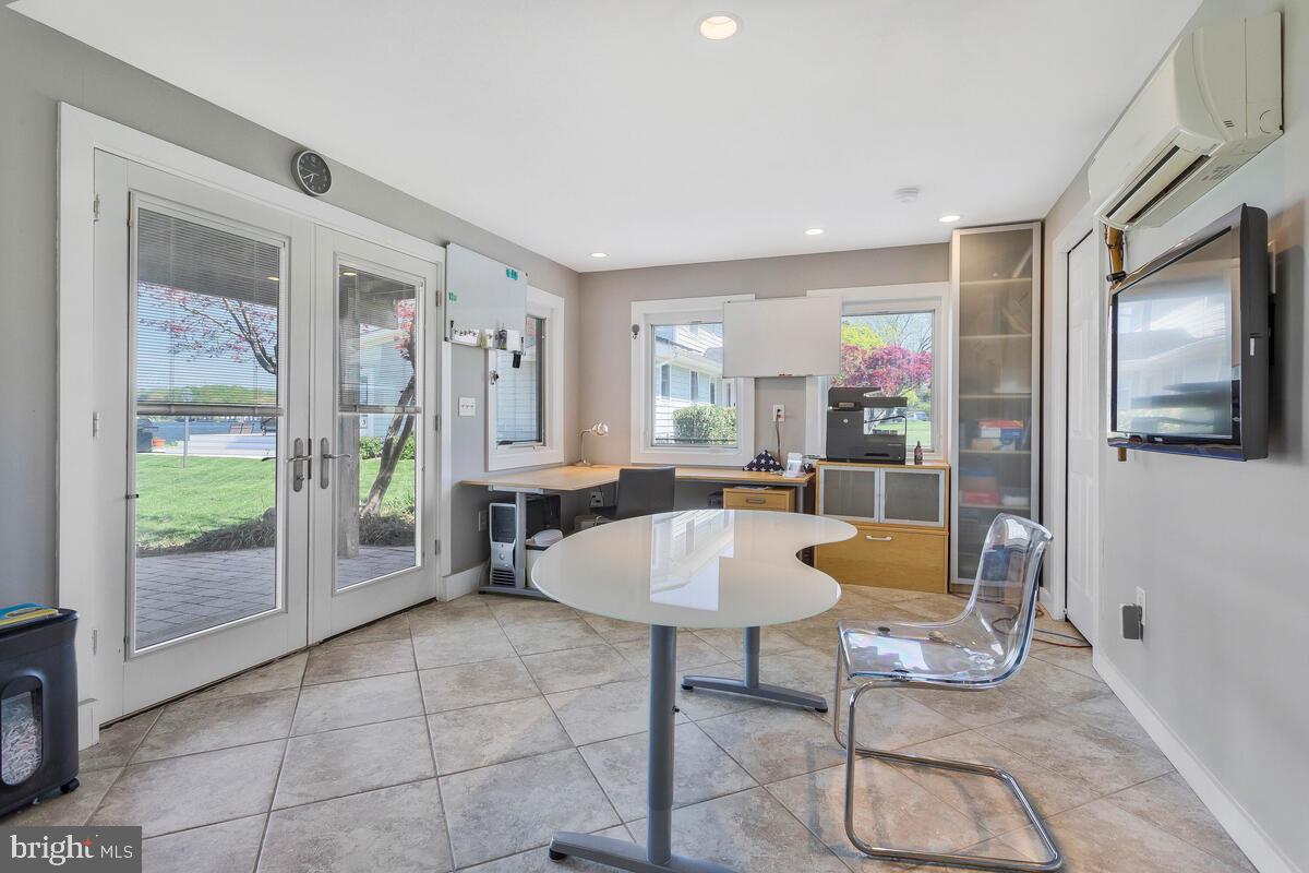 201 Edgewater Drive Edgewater, MD 21037 - Photo 28 of 49 a living room with furniture a flat screen tv and a floor to ceiling window