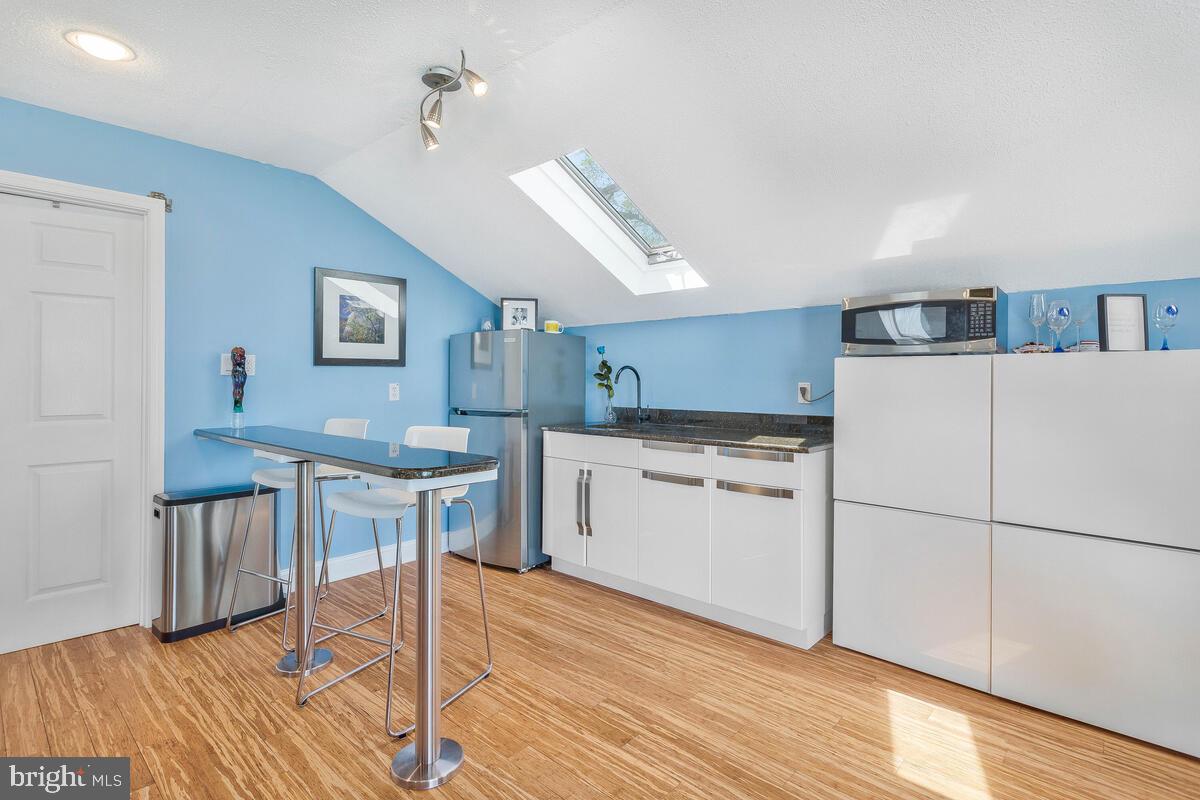 201 Edgewater Drive Edgewater, MD 21037 - Photo 31 of 49 a kitchen with white cabinets and white appliances