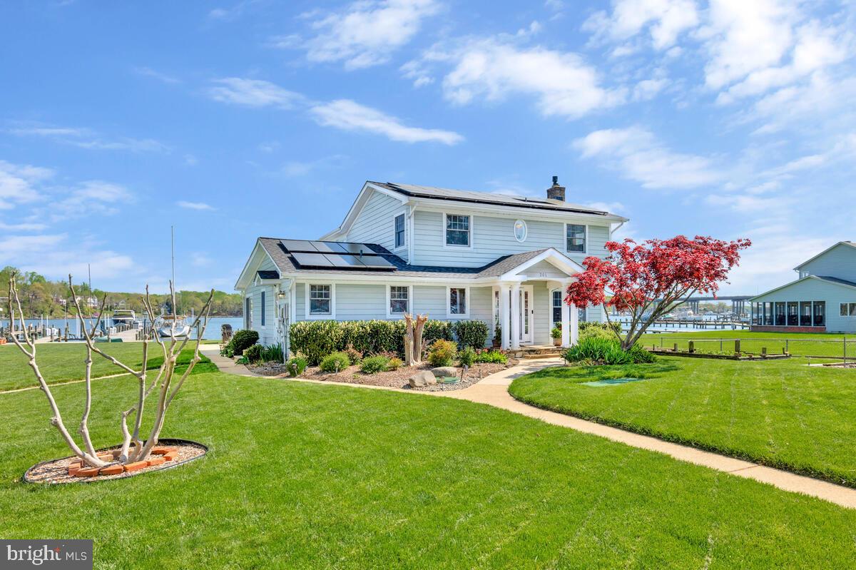201 Edgewater Drive Edgewater, MD 21037 - Photo 5 of 49 a front view of a house with a yard table and chairs