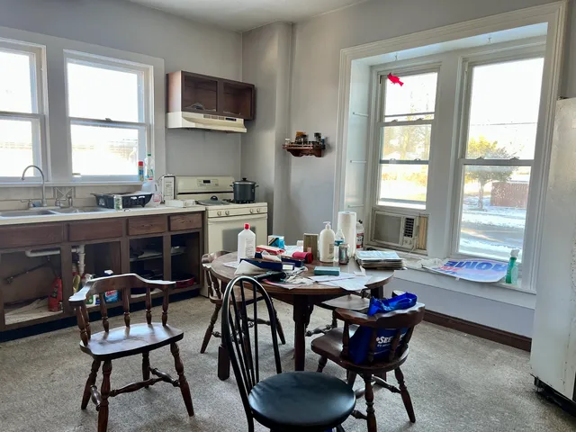 a view of a dining room with furniture and a window