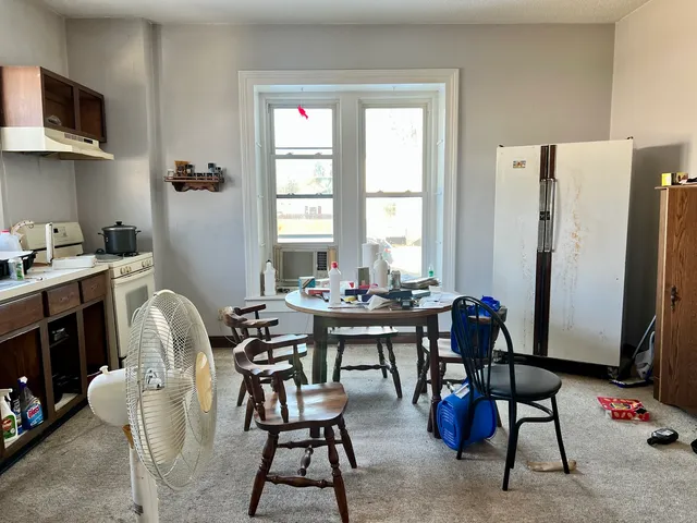 a view of a dining room with furniture and a window