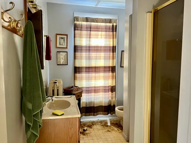 a bathroom with a sink mirror and a window