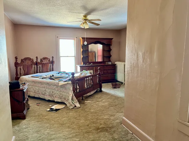 a bed sitting in a bedroom next to a window