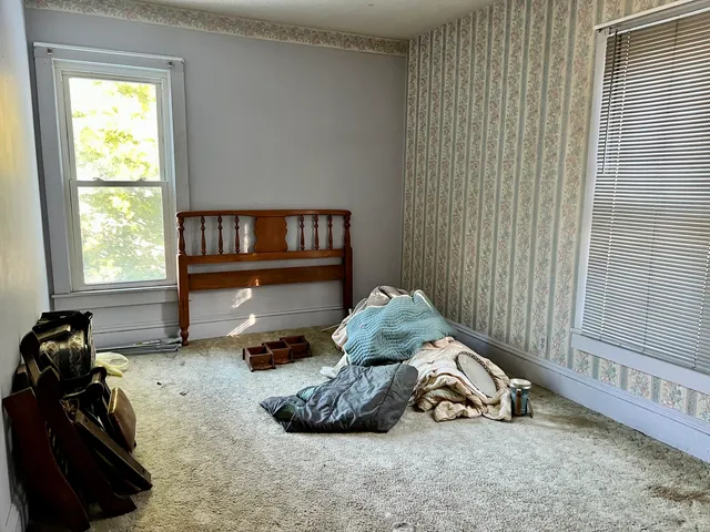 a view of small space with wooden floor and a bathroom