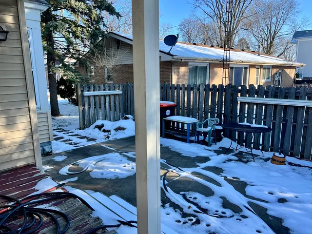 a front view of a house with garden and patio