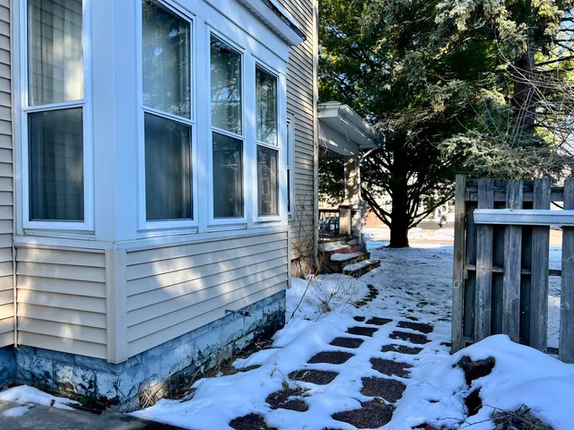 a backyard of a house with barbeque oven
