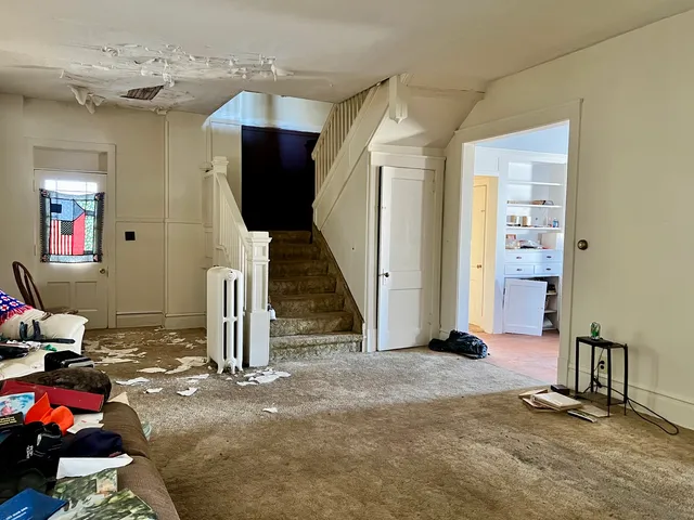 a view of a livingroom with furniture and an empty room