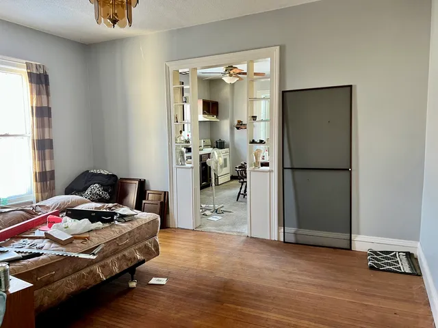 a bedroom with a bed and a mirror