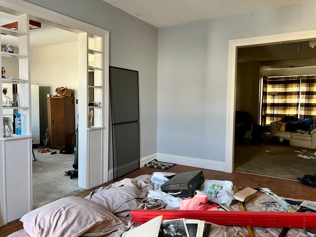 a bedroom with furniture and a window