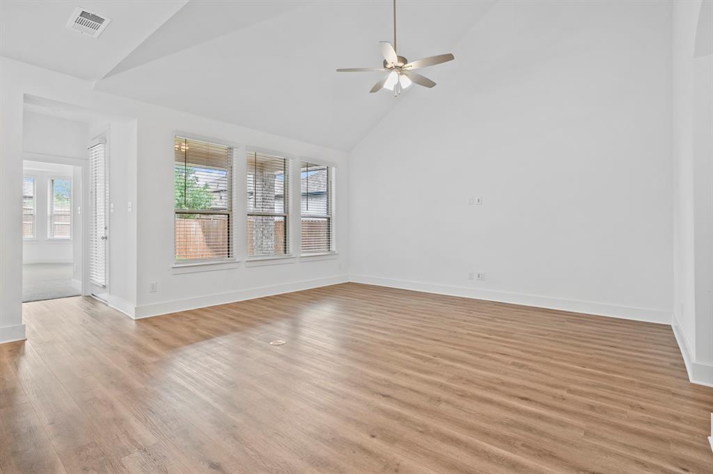 1801 Eagle Landing Van Alstyne, TX 75495 - Photo 10 of 27 Empty room featuring light wood finished floors, a ceiling fan, and high vaulted ceiling