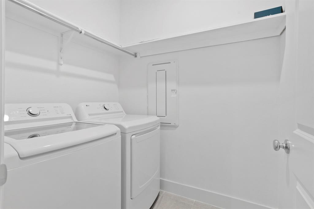 1801 Eagle Landing Van Alstyne, TX 75495 - Photo 11 of 27 Washroom featuring washing machine and dryer, electric panel, and light tile patterned floors