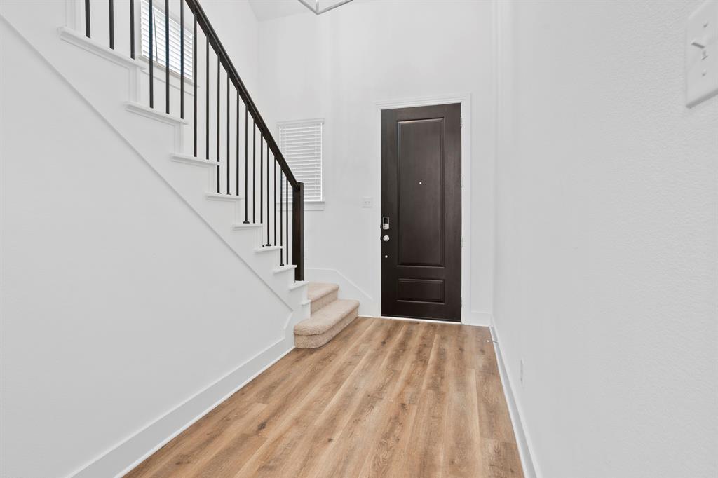 1801 Eagle Landing Van Alstyne, TX 75495 - Photo 2 of 27 Foyer with wood finished floors and stairway