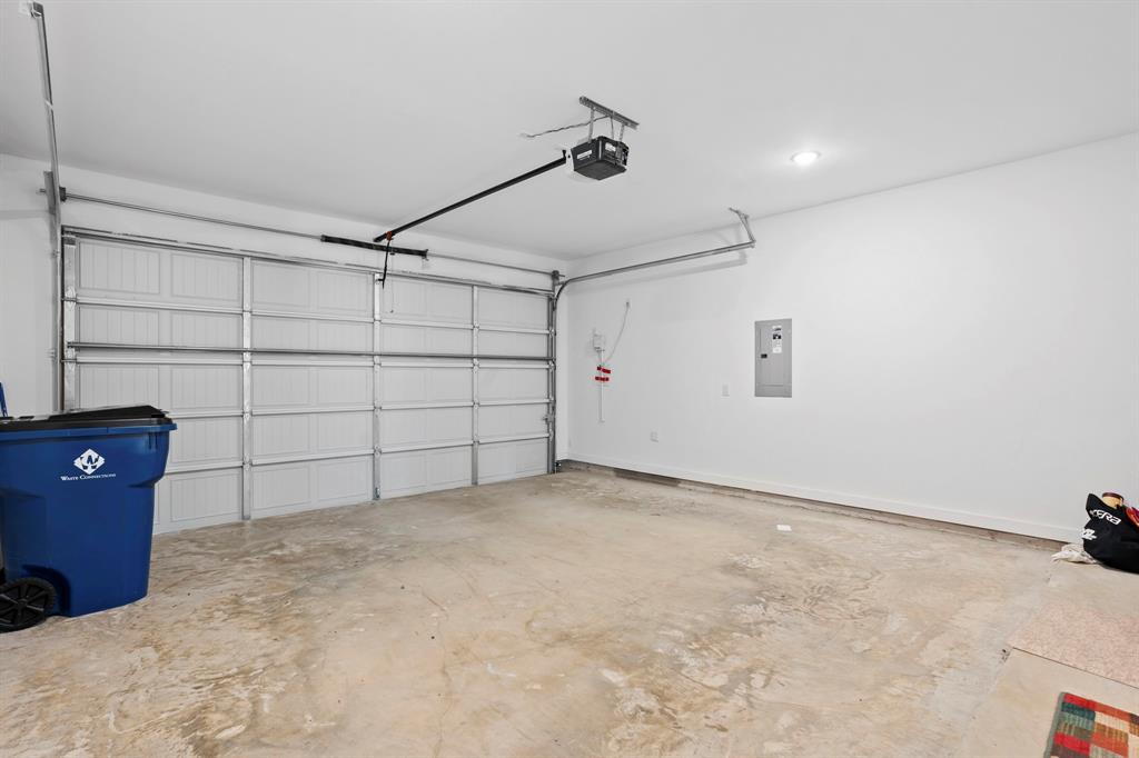 1801 Eagle Landing Van Alstyne, TX 75495 - Photo 21 of 27 Garage with electric panel and a garage door opener