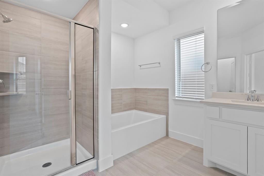1801 Eagle Landing Van Alstyne, TX 75495 - Photo 8 of 27 Bathroom with a stall shower, a bath, and vanity