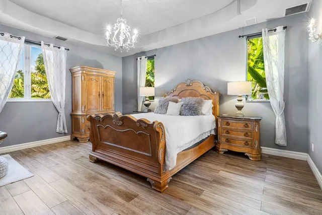 a bathroom with a double vanity sink a mirror and a bathtub