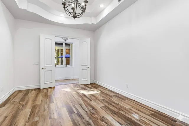an empty room with windows and cabinet