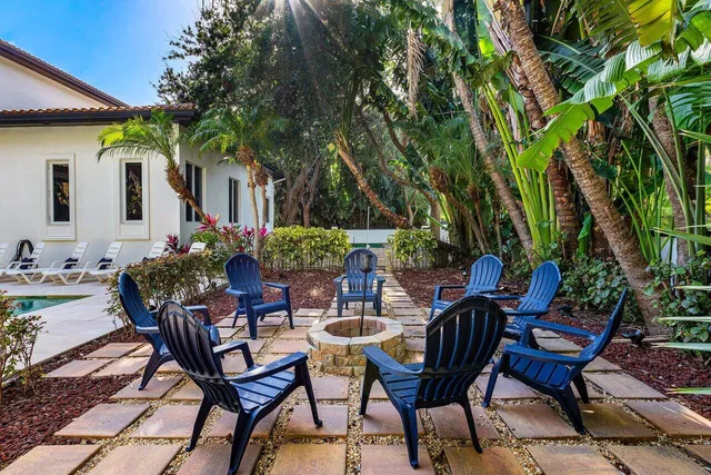 a view of a patio with table and chairs and potted plants