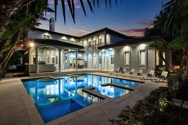 a view of a swimming pool with chairs