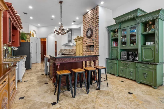 a dining room filled with furniture and a kitchen view