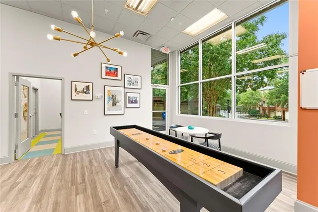 a room with musical instrument pool table furniture and windows