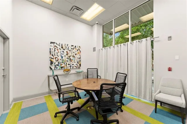 a view of a dining room with furniture and a rug