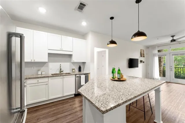 a kitchen with kitchen island granite countertop a sink and center island