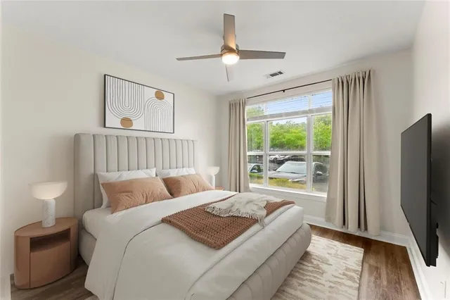 a bedroom with a bed and a large window