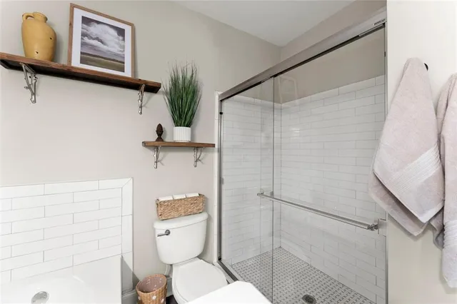 a bathroom with a toilet and a shower