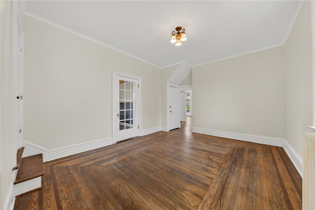 65 2nd Street Slatington, PA 18080 - Photo 16 of 46 This living area features rich hardwood flooring and a classic French door leading to another room.