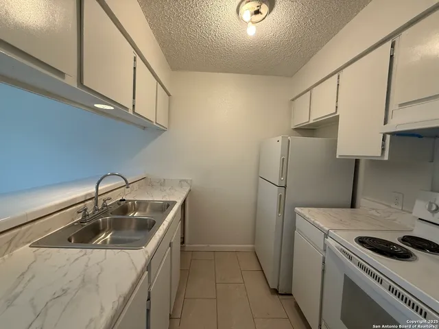 a kitchen that has a sink and a stove