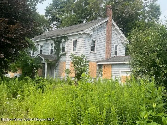 a view of a lake with a yard and wooden fence