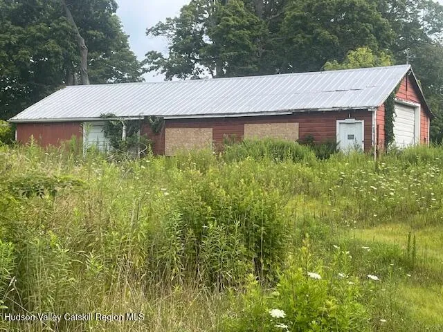 a aerial view of a house with a yard and potted plants