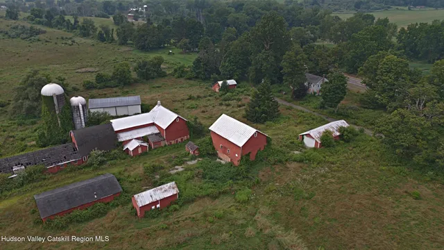 a backyard of a house with lots of green space table and chairs