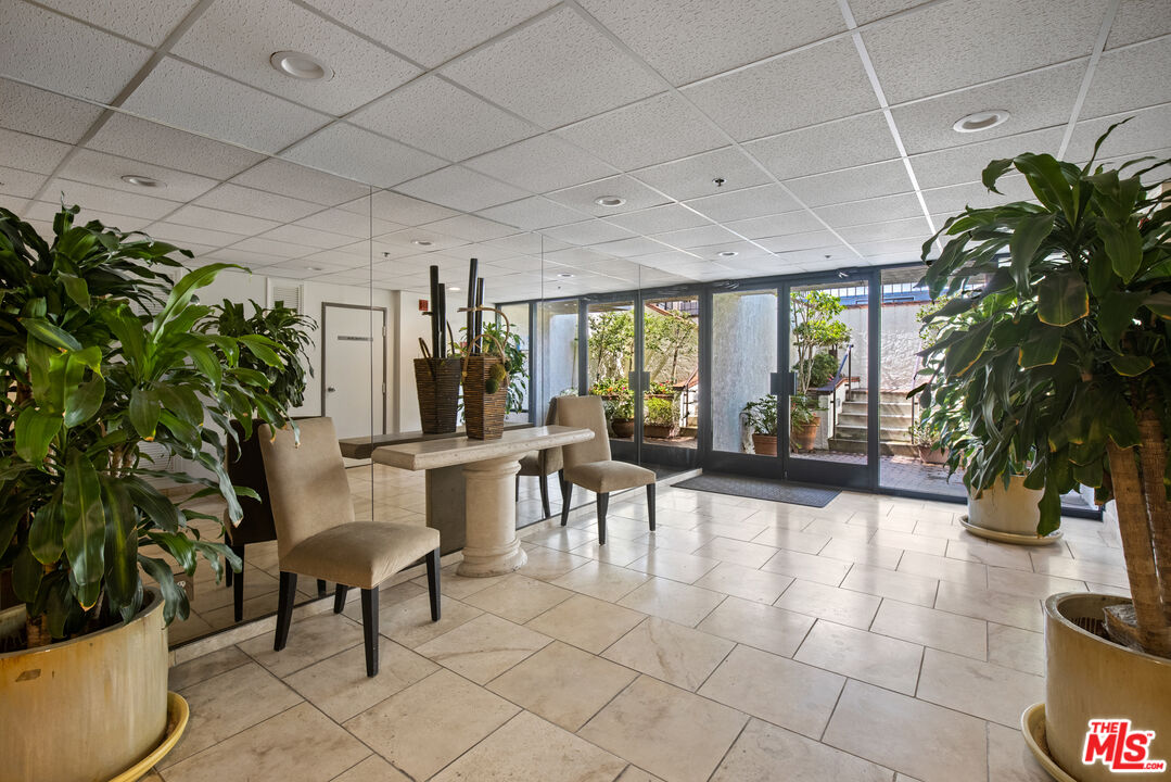 432 South Hamel Road, Unit 302 Los Angeles, CA 90048 - Photo 3 of 20 a view of a livingroom with furniture and floor to ceiling window