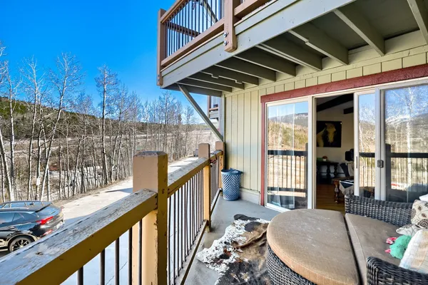 a view of balcony with wooden floor and outdoor seating