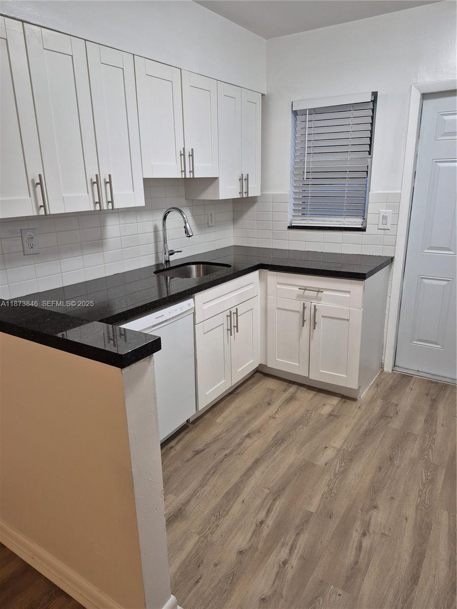 216 Southwest 9th Street, Unit 2 Hallandale Beach, FL 33009 - Photo 1 of 19 a kitchen with stainless steel appliances granite countertop a sink a stove a refrigerator and cabinets